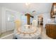 Kitchen with wood cabinets, white appliances, and view into dining area at 1551 Derrick St, Holiday, FL 34690