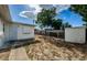 Backyard with shed and walkway leading to the house at 1551 Derrick St, Holiday, FL 34690