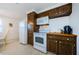 Clean kitchen, featuring white appliances and wood cabinets at 1551 Derrick St, Holiday, FL 34690