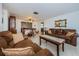 Living room with brown leather couches and a coffee table at 1551 Derrick St, Holiday, FL 34690