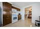 Kitchen with wood cabinets, white appliances, and view to dining area at 1551 Derrick St, Holiday, FL 34690