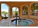 Community hot tub with an octagonal shape, surrounded by arched windows and landscaping at 2757 Via Cipriani # 1132A, Clearwater, FL 33764
