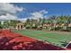 Well-maintained tennis court with red and green surface at 2757 Via Cipriani # 1132A, Clearwater, FL 33764
