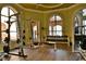 Modern gym with various exercise equipment and large windows at 2757 Via Cipriani # 1132A, Clearwater, FL 33764