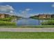 Scenic waterfront view with a brick paved pathway and lush green landscaping at 2757 Via Cipriani # 1132A, Clearwater, FL 33764