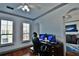 Home office with hardwood floors, dual monitors, and view into living room at 2757 Via Cipriani # 1132A, Clearwater, FL 33764
