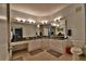 Bathroom features a double vanity, granite countertops, and a large shower at 2757 Via Cipriani # 1132A, Clearwater, FL 33764