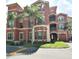 Grand Bellair Condominium building with palm trees and landscaping at 2757 Via Cipriani # 1132A, Clearwater, FL 33764