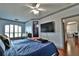 Main bedroom with king bed, large TV, and a view into the living area at 2757 Via Cipriani # 1132A, Clearwater, FL 33764