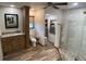 Bright bathroom with neutral walls, mosaic stone floor in the shower, and a granite-topped vanity at 1068 Harbour Cape Pl, Punta Gorda, FL 33983