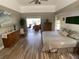 Bright bedroom featuring wood-look floors, a ceiling fan, and sliding glass doors to the lanai at 1068 Harbour Cape Pl, Punta Gorda, FL 33983