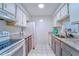 Simple kitchen with white appliances and granite countertops at 9205 Tudor Dr # C209, Tampa, FL 33615