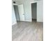 Bedroom with wood-look floors and a walk-in closet at 9205 Tudor Dr # C209, Tampa, FL 33615