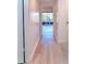 Light hallway with wood-look flooring leading to rooms at 9205 Tudor Dr # C209, Tampa, FL 33615