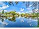 Serene view of a canal reflecting the sky and surrounding homes at 9205 Tudor Dr # C209, Tampa, FL 33615