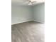 Spacious living room featuring light grey walls and wood-look flooring at 9205 Tudor Dr # C209, Tampa, FL 33615
