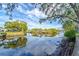 Peaceful canal view with waterfront homes and lush vegetation at 9205 Tudor Dr # C209, Tampa, FL 33615