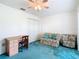 Bedroom with floral sofa and teal carpeting at 11111 Dormie Dr, San Antonio, FL 33576