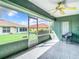 Relaxing screened porch with tiled floor, ceiling fan, and backyard view at 11111 Dormie Dr, San Antonio, FL 33576