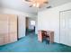 Bedroom with teal carpeting, a wooden desk, and built-in wardrobe at 11111 Dormie Dr, San Antonio, FL 33576