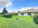 Large backyard with lush lawn, hedges, and a tree stump at 11111 Dormie Dr, San Antonio, FL 33576