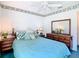 Spacious bedroom with wood dresser and teal bedding at 11111 Dormie Dr, San Antonio, FL 33576