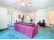 Living room features a purple sofa and teal carpet at 11111 Dormie Dr, San Antonio, FL 33576