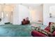 Living area with teal carpet, maroon sofa, and views into other rooms at 11111 Dormie Dr, San Antonio, FL 33576