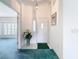 Bright and airy entryway with a white door and a large vase of flowers at 11111 Dormie Dr, San Antonio, FL 33576