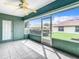Spacious screened porch with tile floors, ceiling fan and access to backyard at 11111 Dormie Dr, San Antonio, FL 33576