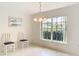 Bright dining room with a chandelier and view to backyard at 11111 Dormie Dr, San Antonio, FL 33576