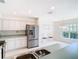 Kitchen boasts stainless steel appliances and white cabinets at 11111 Dormie Dr, San Antonio, FL 33576