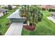 Single-story house with green walls, gray roof, and palm trees at 11111 Dormie Dr, San Antonio, FL 33576