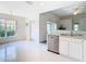 Kitchen features stainless steel appliances and white cabinets at 11111 Dormie Dr, San Antonio, FL 33576