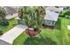 Single-story house with green walls, gray roof, and palm trees at 11111 Dormie Dr, San Antonio, FL 33576