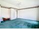 Primary bedroom with teal carpet, a ceiling fan, and a door to outside at 11111 Dormie Dr, San Antonio, FL 33576