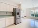 Kitchen with stainless steel appliances and view of dining area at 11111 Dormie Dr, San Antonio, FL 33576