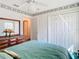 Charming bedroom with double closets and teal bedding at 11111 Dormie Dr, San Antonio, FL 33576