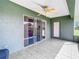 Bright screened porch features tile flooring, ceiling fan, and access to kitchen at 11111 Dormie Dr, San Antonio, FL 33576