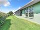 House exterior and backyard with green grass and hedges at 11111 Dormie Dr, San Antonio, FL 33576