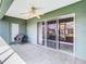 Relaxing screened porch with tile floor, ceiling fan, and sliding glass doors at 11111 Dormie Dr, San Antonio, FL 33576