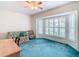 Relaxing living room with bay window and teal carpeting at 11111 Dormie Dr, San Antonio, FL 33576