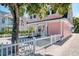 Charming pink house with white picket fence and gravel driveway at 963 Highland Ave, Dunedin, FL 34698