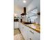 Modern kitchen with white cabinets, butcher block countertops, and black appliances at 963 Highland Ave, Dunedin, FL 34698