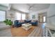 Bright living room featuring two blue sofas, a coffee table, and large windows at 963 Highland Ave, Dunedin, FL 34698