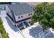 Pink house with gray roof, white fence, and small yard at 963 Highland Ave, Dunedin, FL 34698