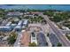 Aerial view of a residential community near the water, featuring new construction and established homes at 963 Highland Ave, Dunedin, FL 34698
