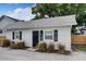 Charming white guest house with black shutters and a black door at 963 Highland Ave, Dunedin, FL 34698