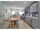 Modern kitchen with grey cabinets, stainless steel appliances and tropical wallpaper at 963 Highland Ave, Dunedin, FL 34698
