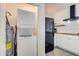 Compact laundry room with stackable washer and dryer at 963 Highland Ave, Dunedin, FL 34698